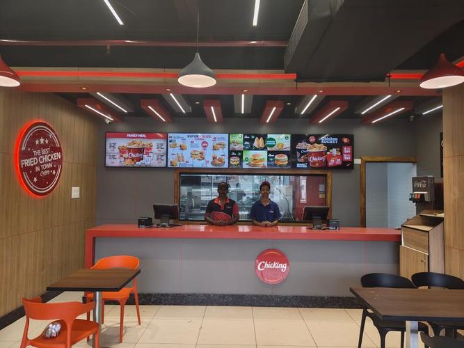 Inside a live Chicking outlet — counter, menu boards and team